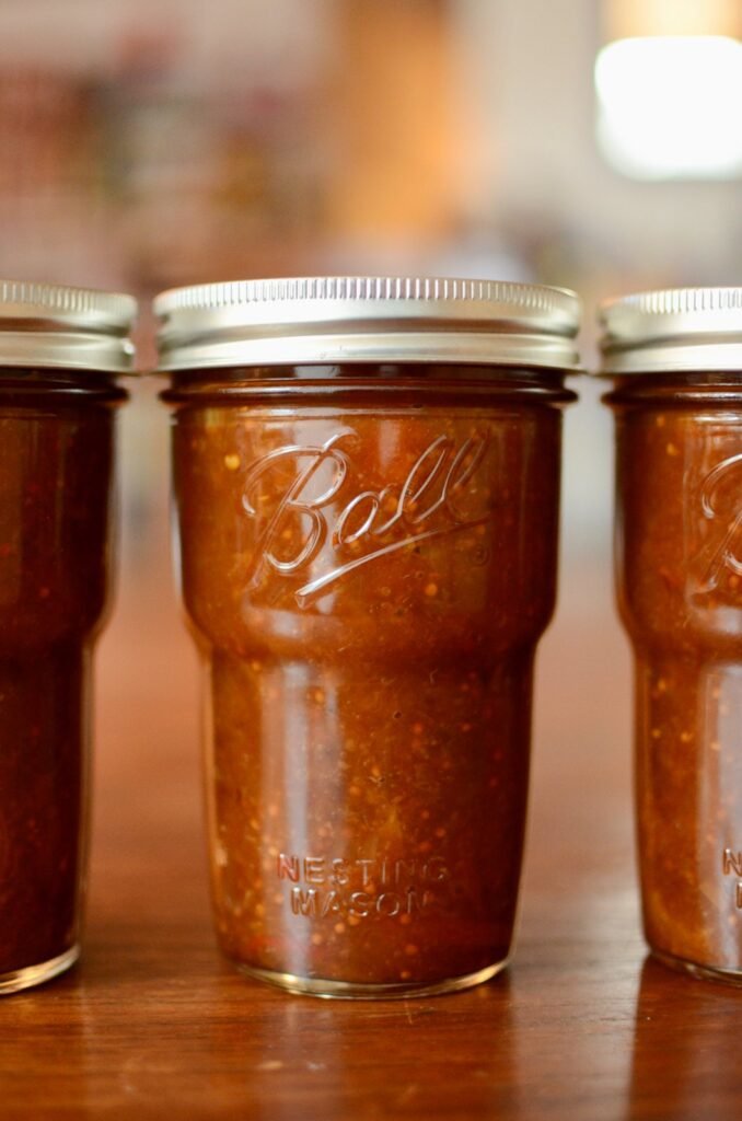 Close up of the lemon peach turmeric chutney in a jar.